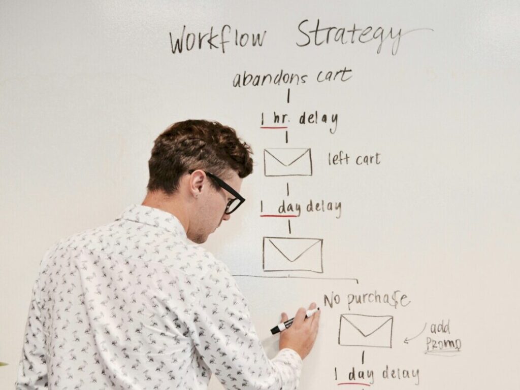 man writing on white board